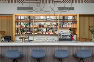 a bar in a restaurant with blue chairs at Radisson Hotel Kaunas in Kaunas