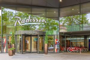 a building with a sign on the front of it at Radisson Hotel Kaunas in Kaunas
