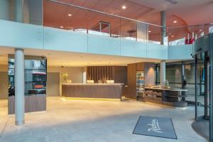 a large lobby with a staircase in a building at Radisson Hotel Kaunas in Kaunas