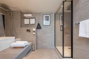 a bathroom with a shower and a sink at Radisson Hotel Kaunas in Kaunas