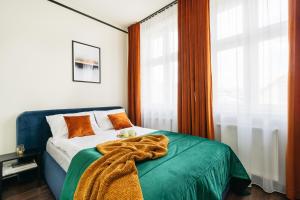 a bedroom with a bed with a blanket on it at Estery12 - LoftAffair Collection in Krakow