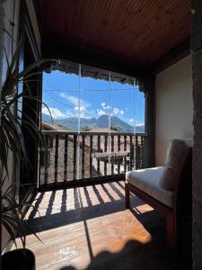 a living room with a large window with a view at El Refugio del Busgosu in Pen