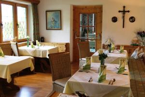 a restaurant with two tables with white tablecloths at Hotel Geisler Tulfes in Tulfes