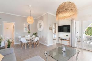 a living room with a table and a dining room at Casa a metros del Mar in Playa de Muro