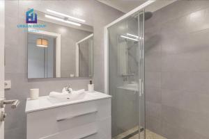 a bathroom with a sink and a glass shower at Casa a metros del Mar in Playa de Muro +13 photos