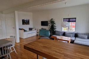 a living room with a couch and a table at Fjøsen - Bleik Beach in Bleik