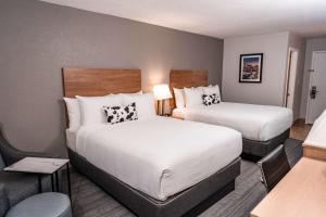 a hotel room with two beds and a desk at Aiden by Best Western Denver West Golden in Golden