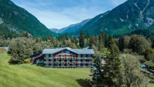 an aerial view of a large house in the mountains at Hôtel Le Labrador in Chamonix-Mont-Blanc