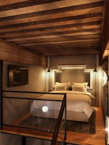 a bedroom with a bed and a tv at Cour des Loges Lyon, A Radisson Collection Hotel in Lyon
