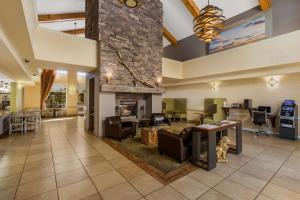 a lobby with a living room with a fireplace at SureStay Plus Hotel by Best Western Tempe University in Tempe