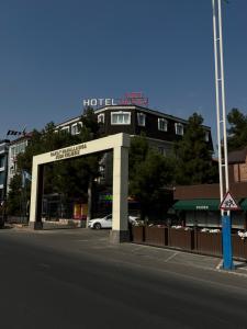 a hotel entrance with a car in front of a building at Art Plaza Hotel in Tashkent