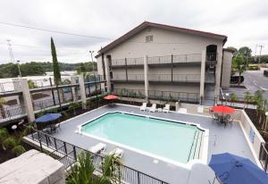 a swimming pool on the balcony of a house at Bhagat Hotels Stone Mountain Atlanta BW Signature Collection in Tucker