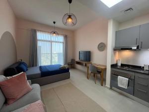 a bedroom with a bed and a desk in a room at Warm and Elegant Studio in Dubai in Dubai