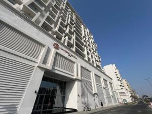 a building with white shutters on the side of it at Warm and Elegant Studio in Dubai in Dubai