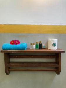 a wooden shelf with towels and other items on it at Amba Kola Udawalawa in Udawalawe