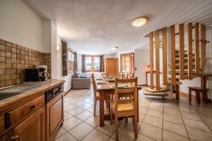 a kitchen with a table and a dining room at Chalet La Grangerie in Montriond
