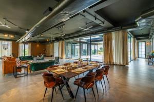 a large dining room with a long table and chairs at StayVista's Anantam - Villa with Massive Outdoor Pool with Deck & Sprawling Lawn in New Delhi