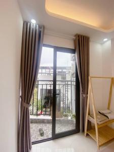 a room with a large window with a view of a balcony at Cozy apartment w/ 2 private BR & free bike parking in Hanoi