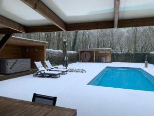 un patio con piscina, sillas y mesa en Wellness Hasselt B&B, en Hasselt