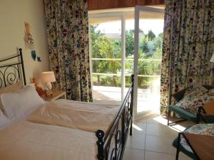1 dormitorio con cama y ventana grande en B&B Domaine Méditerranée en Paraza
