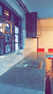 a kitchen with a sink and a counter top at Sajaairbnb in Narok