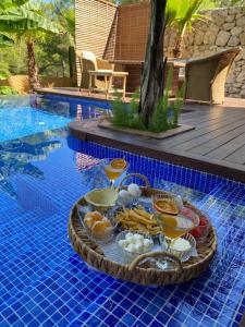 a tray of food on a table next to a pool at Metavilla in Kemer