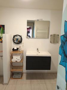 a bathroom with a sink and a mirror at Gallery Home in Brussels