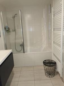 a white bathroom with a shower and a tub at Gallery Home in Brussels