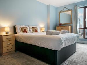 a bedroom with a large bed with a large mirror at Pass the Keys Incredible Cityscape Views Balcony City Centre in Belfast