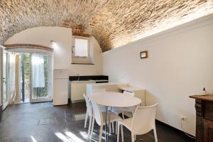 a kitchen and dining room with a table and chairs at Primo mare, borgo dei pescatori in Cervo