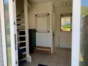 um quarto com uma escada e um banco num quarto em Groot vakantiehuis direct aan het Zeeuwse strand em Kamperland