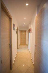 a corridor of a hallway with doors and tile floors at EMMEA8 APARTMENTS RELAX in Angri