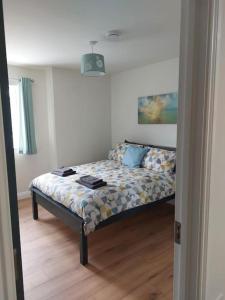 a bedroom with a bed in a room at Stunning New 3 Bed Townhouse in Belmullet