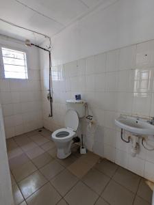 a bathroom with a toilet and a sink at Karibu Homestay Moshi in Moshi