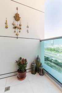 a room with a window and a potted plant at Private Room in Bright & Cozy Apt Near Downtown, Near Metro, Pool, Gym in Dubai