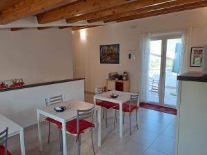uma cozinha e sala de jantar com duas mesas e cadeiras em Tana del Riccio em Ortona