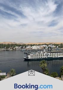 a cruise ship is docked in a body of water at Aswan sunrise in Aswan