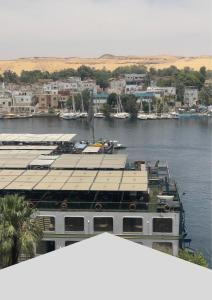 a cruise ship docked in a body of water at Aswan sunrise in Aswan