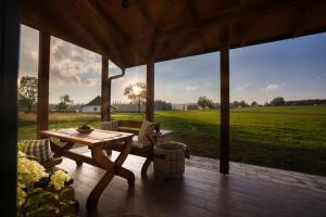 porche con mesa, sillas y vistas a un campo en Chalupa Na Rejvízu 
