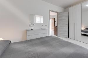 a bedroom with a large bed and a bathroom at Chalet La Greta - Casa vista campi in Firenzuola