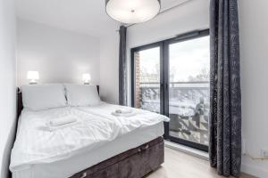 Posteľ alebo postele v izbe v ubytovaní Rent like home - Dwie Motławy III z parkingiem