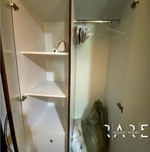 a bathroom with a glass shower stall with shelves at Rare Holiday Homes presents Large 1 Bed in a peaceful community of JVC -La Riviera Estate B R106 in Dubai