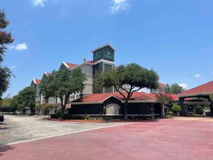 a large building with a clock tower on top of it at La Quinta by Wyndham Dallas Arlington South in Arlington