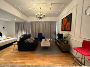 a living room with a couch and a tv at Luxurious Condo in Heart of Kuala Lumpur with Rooftop Garden in Kuala Lumpur