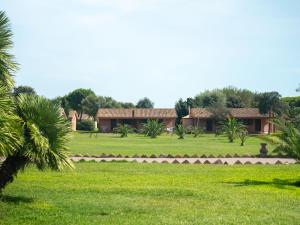 a house in the middle of a green field at Gitavillage California in Montalto di Castro