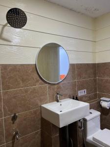 a bathroom with a sink and a mirror at The Garden House Lahad Datu in Lahad Datu