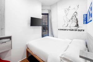 a bedroom with a bed and a sign on the wall at BeHome by LuxUrban in New York