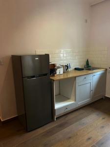 a kitchen with a stainless steel refrigerator and a counter at Pokoje Gościnne Atelier in Orneta