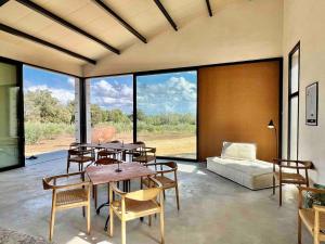 a living room with a table and chairs and a bed at Los Dos Caballeros Winery & Vacation Rental in Llubí