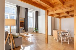 a living room with a wooden ceiling and a table at V26 Freedom Lodge Apartment in Budapest